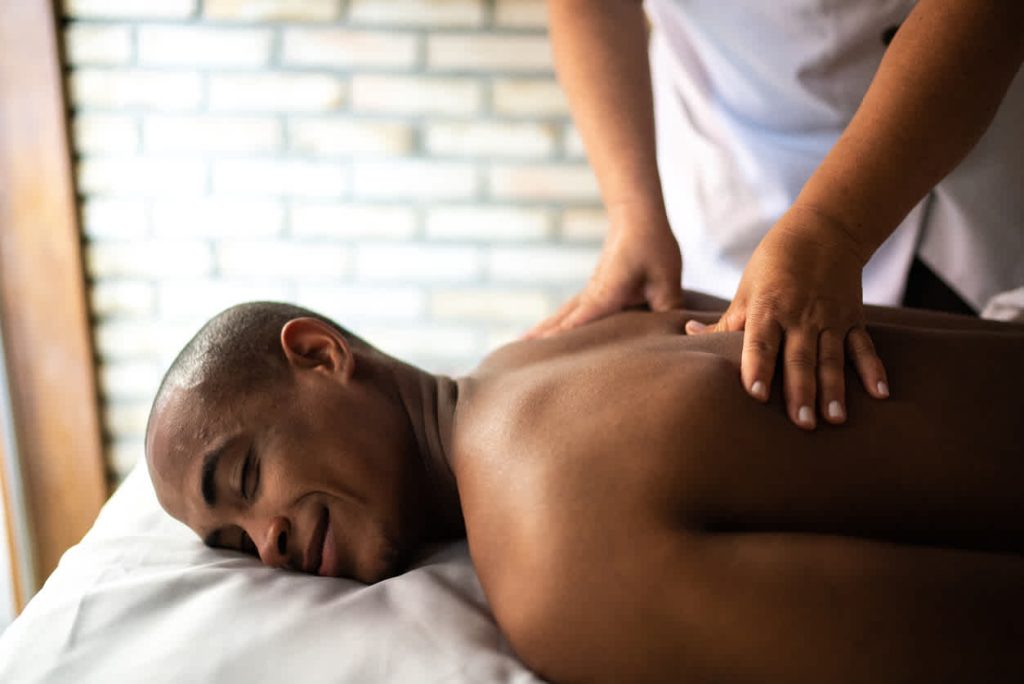 black-man-smiling-getting-back-massage
